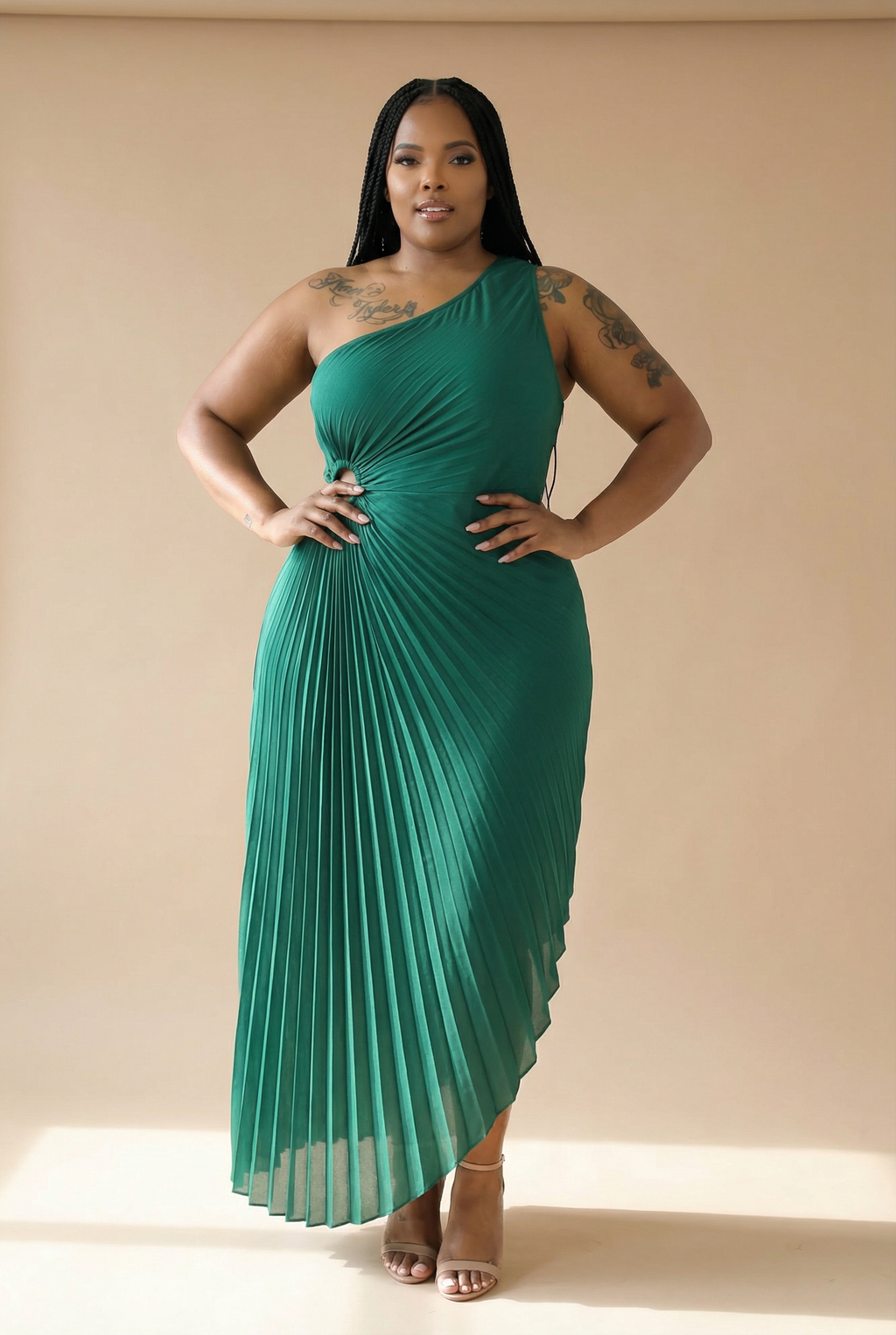Woman wearing a green one-shoulder dress against a beige background